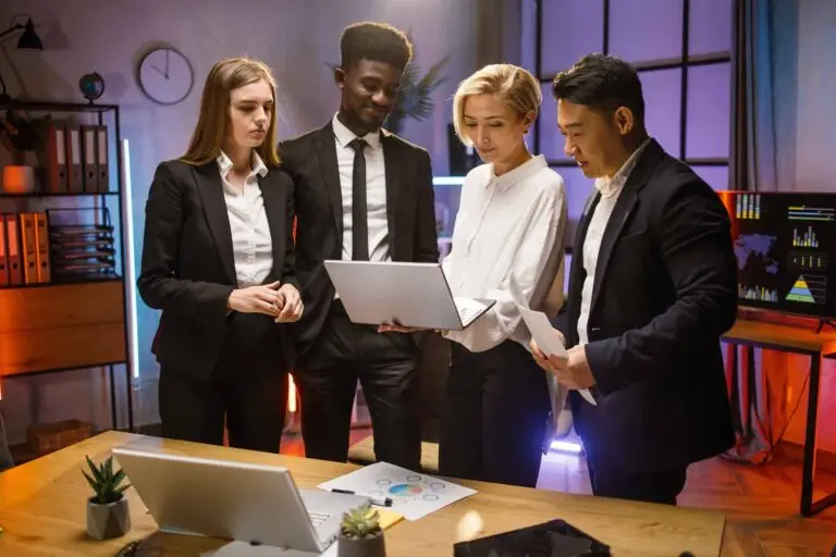 four-colleagues-brainstorming-at-dark-office.jpg